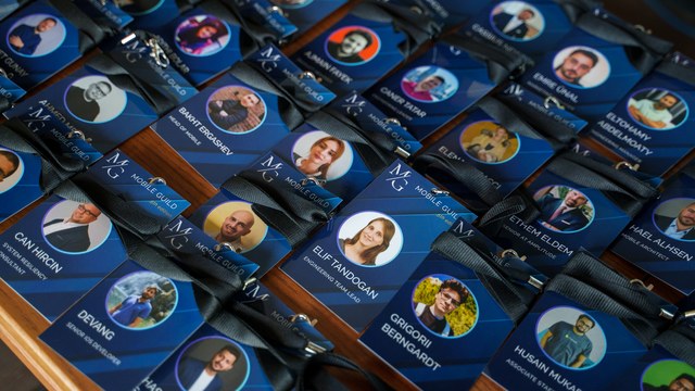 Mobile Guild attendee badges laid out on a table